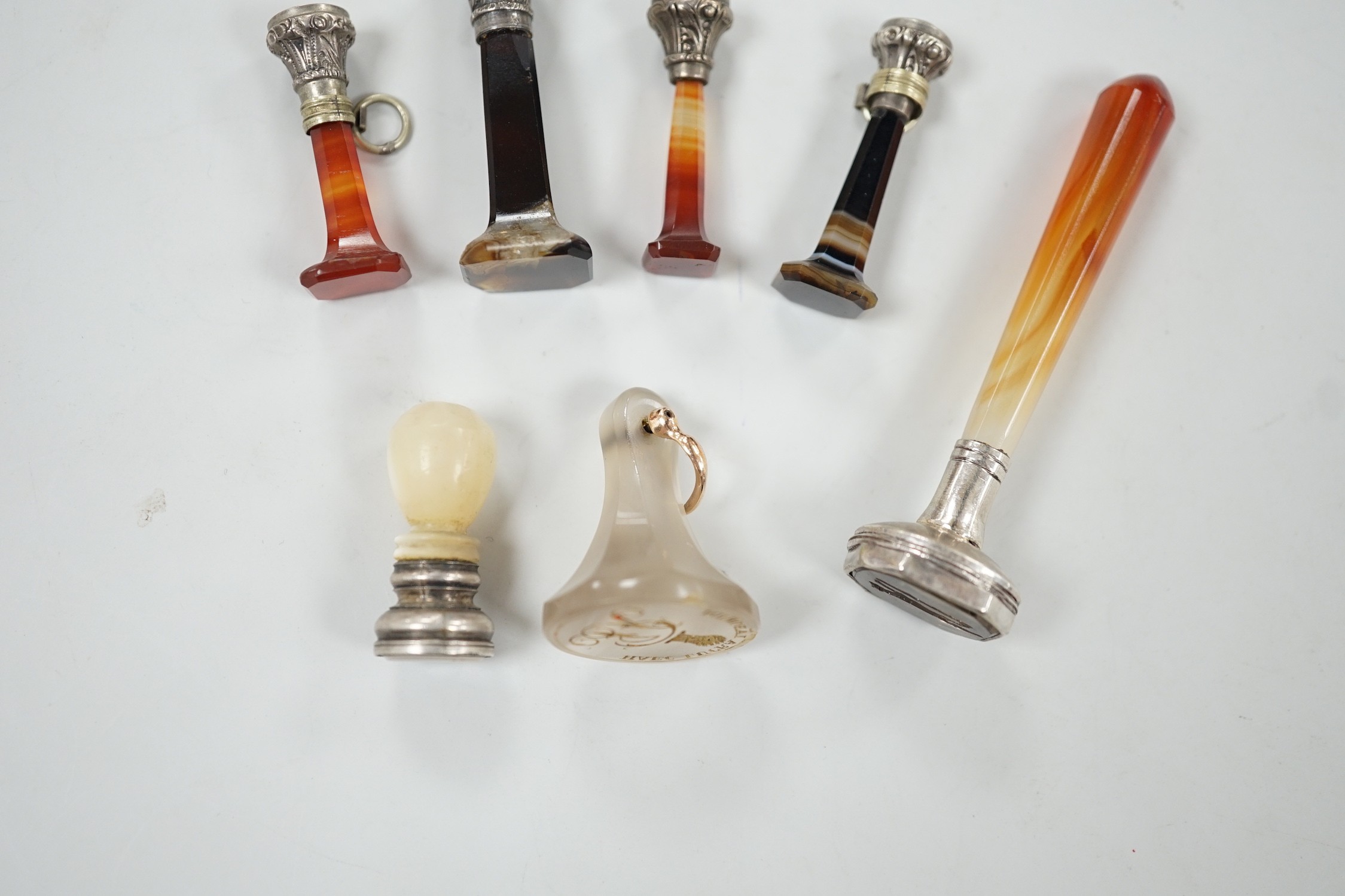 Five assorted 19th century white metal mounted agate seals, largest 61mm, a similar white metal and mother of pearl mounted seal and a white chalcedony seal with monogrammed matrix.
